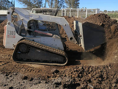 Earth-moving work on a chicken farm in Southern California with a Bobcat T300 compact track loader with McLaren NextGen TDF series rubber tracks.